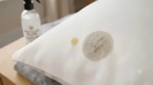 Testing a mild cleaning solution on a small area of the pillow.