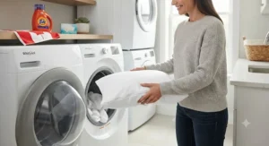 An easy-care, machine-washable dust mite pillow protector being placed in a laundry setting.