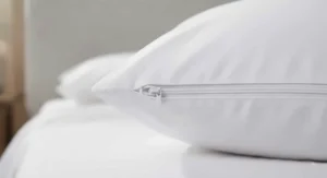 Close-up of a zippered waterproof pillow protector showing secure full enclosure design.