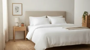 A hypoallergenic medium pillow set queen size resting on crisp white cotton sheets.
